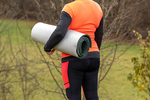 Woman carrying a yoga mat, a Photo by Grafvision photography
