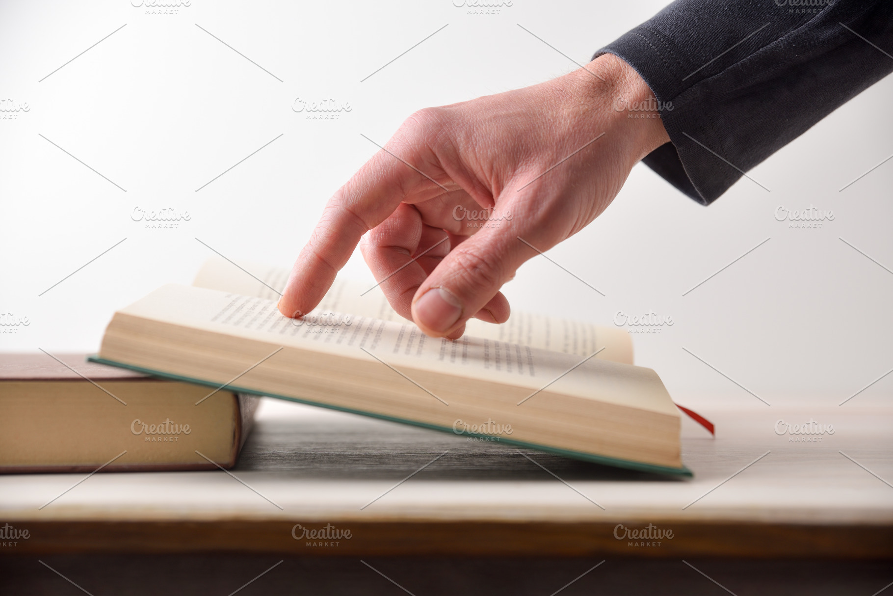 Person reading a book pointing at text with your finger, a School & Education Photo by Davizro's Market