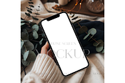 iPhone Mockup with Leaves & Lights, a Mockup by MockupWizard (Thumbnail 1 of 3)