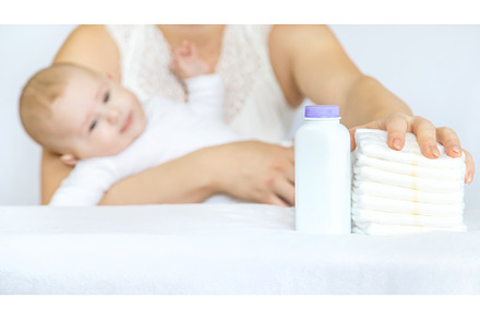 mother changes baby's diaper on a, a Person Photo by yanadjana