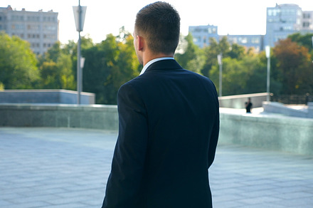 Young businessman with a briefcase featuring street, city, and cityscape