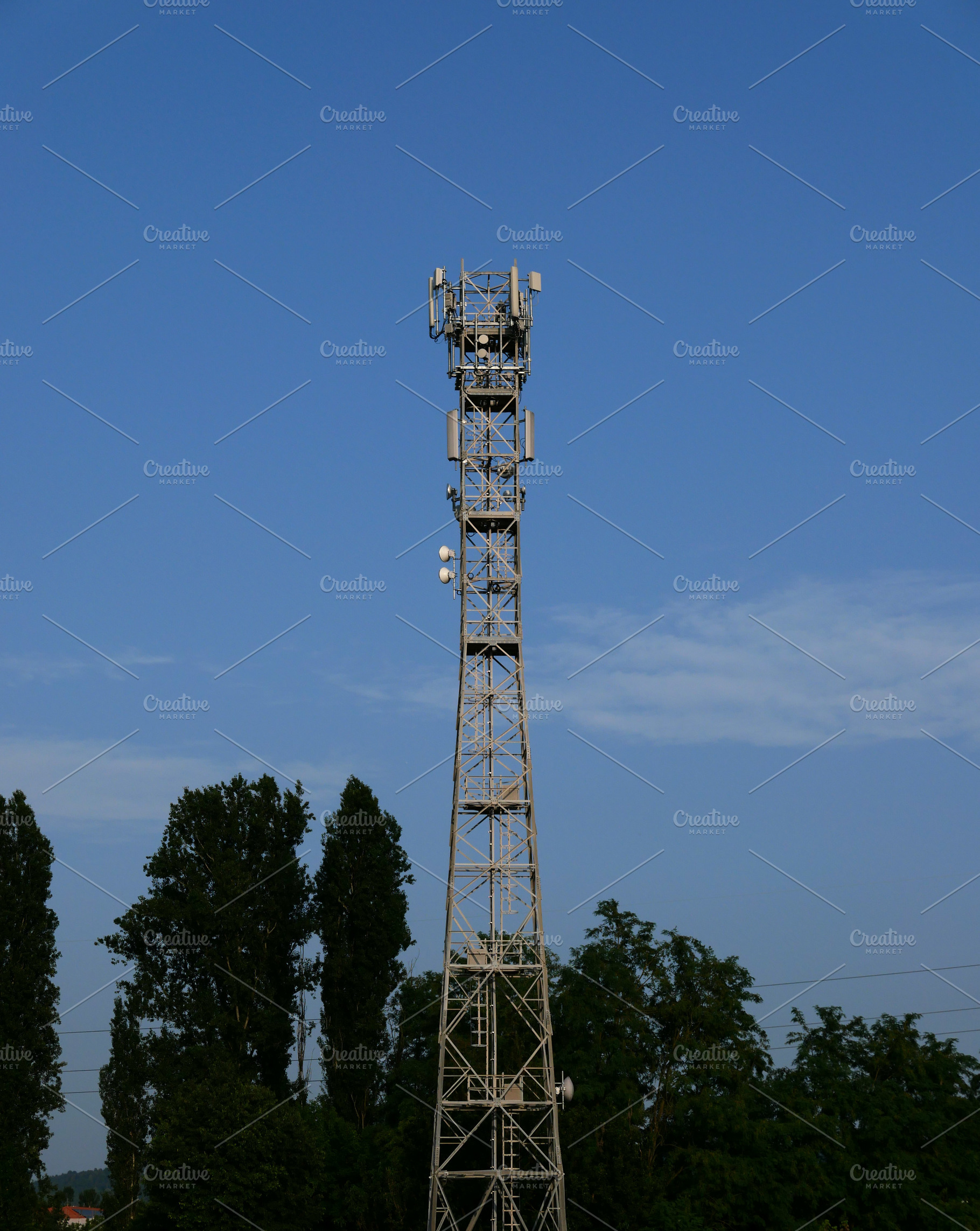communication tower mast over blue sky, a Photo by WorldOfPhotos