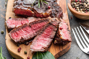 Medium rare Ribeye steak with herbs, a Photo by Volff