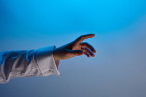 A hand in a white shirt on a blue gradient background, symbolizi, a Person Photo by ndanko