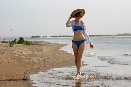 Girl in bikini walks on beach, a Person Photo by Elena Vagengeim