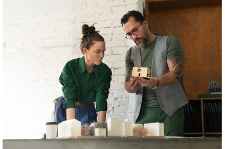 Young couple working as architects, a Business Photo by HalfPoint