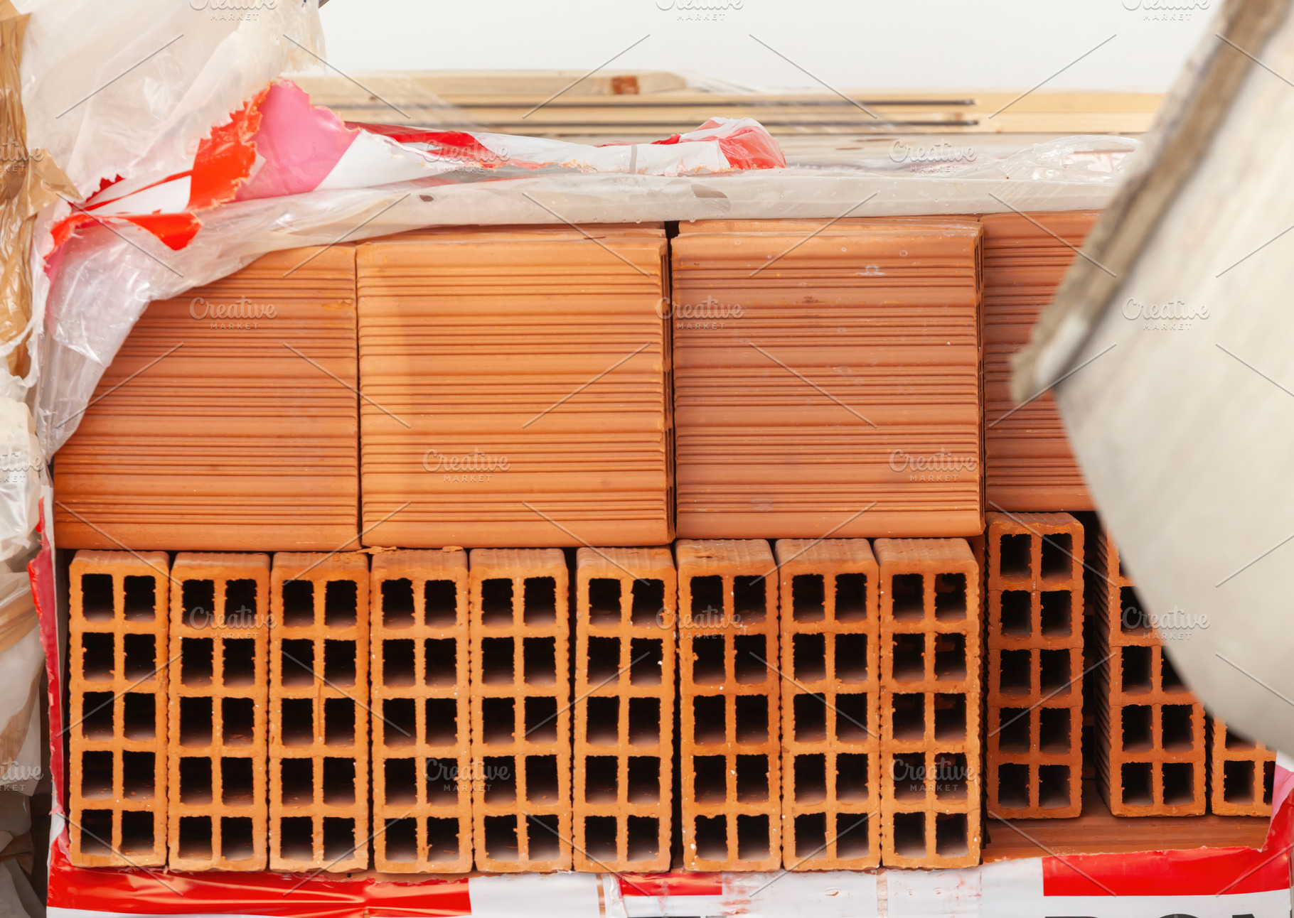 Pallet of hollow bricks ready for building construction, an Industrial Photo by Antonio Gravante Market