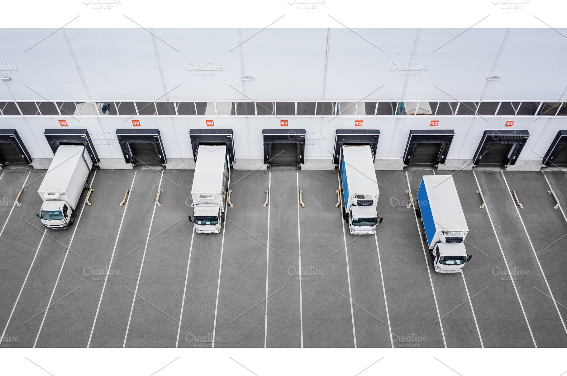 Trucks unloading in distribution hub, a Transportation Photo by a_medvedkov