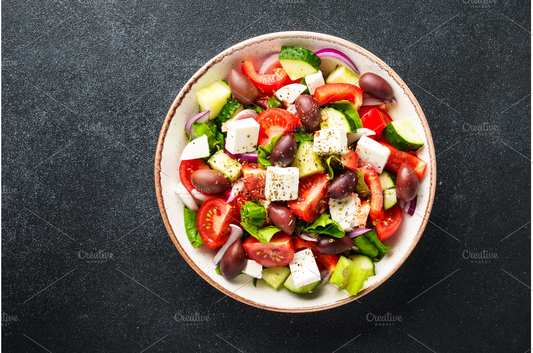 Greek salad in craft plate on black, a Food & Drink Photo by Nadia-nb