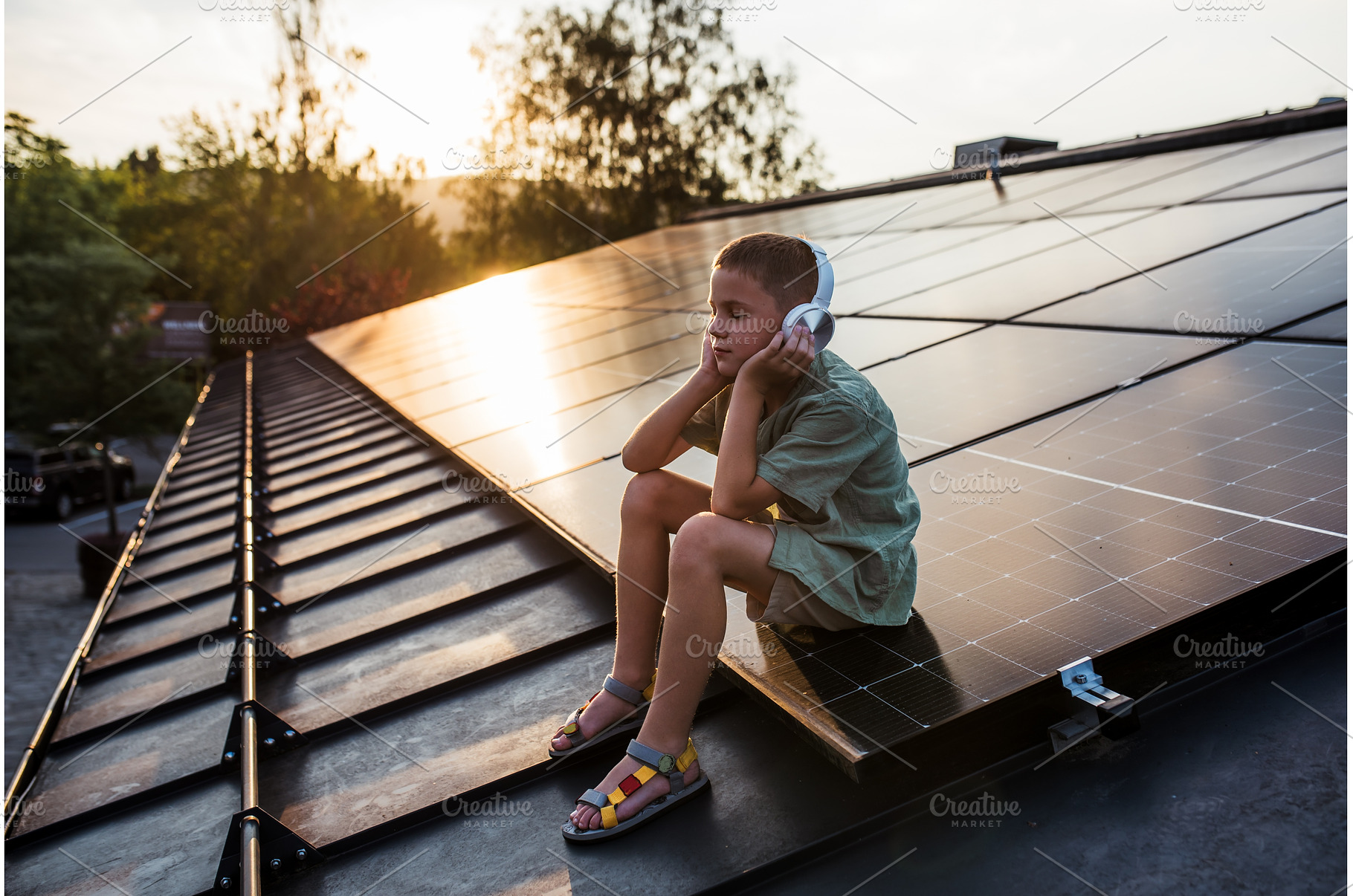 Cute boy sitting on roof with solar, a Technology Photo by HalfPoint
