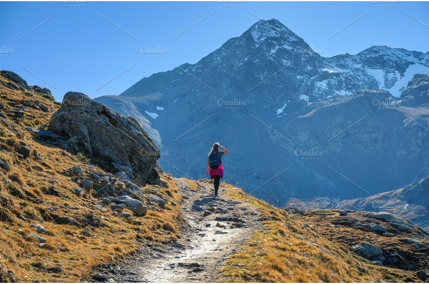 Young woman with backpack hiking, a Nature Photo by den-belitsky