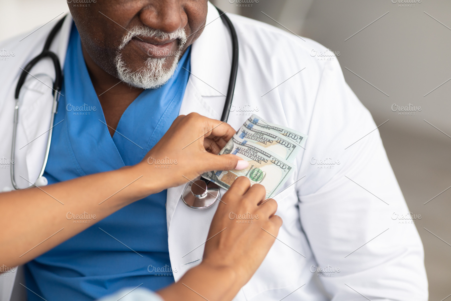 Black female hand putting money in doctor's pocket, closeup, a Photo by Prostock-Studio