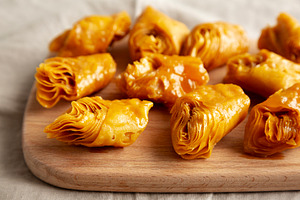 Sweet Homemade Turkish Baklava with Honey on a Wooden Board, sid, a Food & Drink Photo by LiudmylaChuhunova