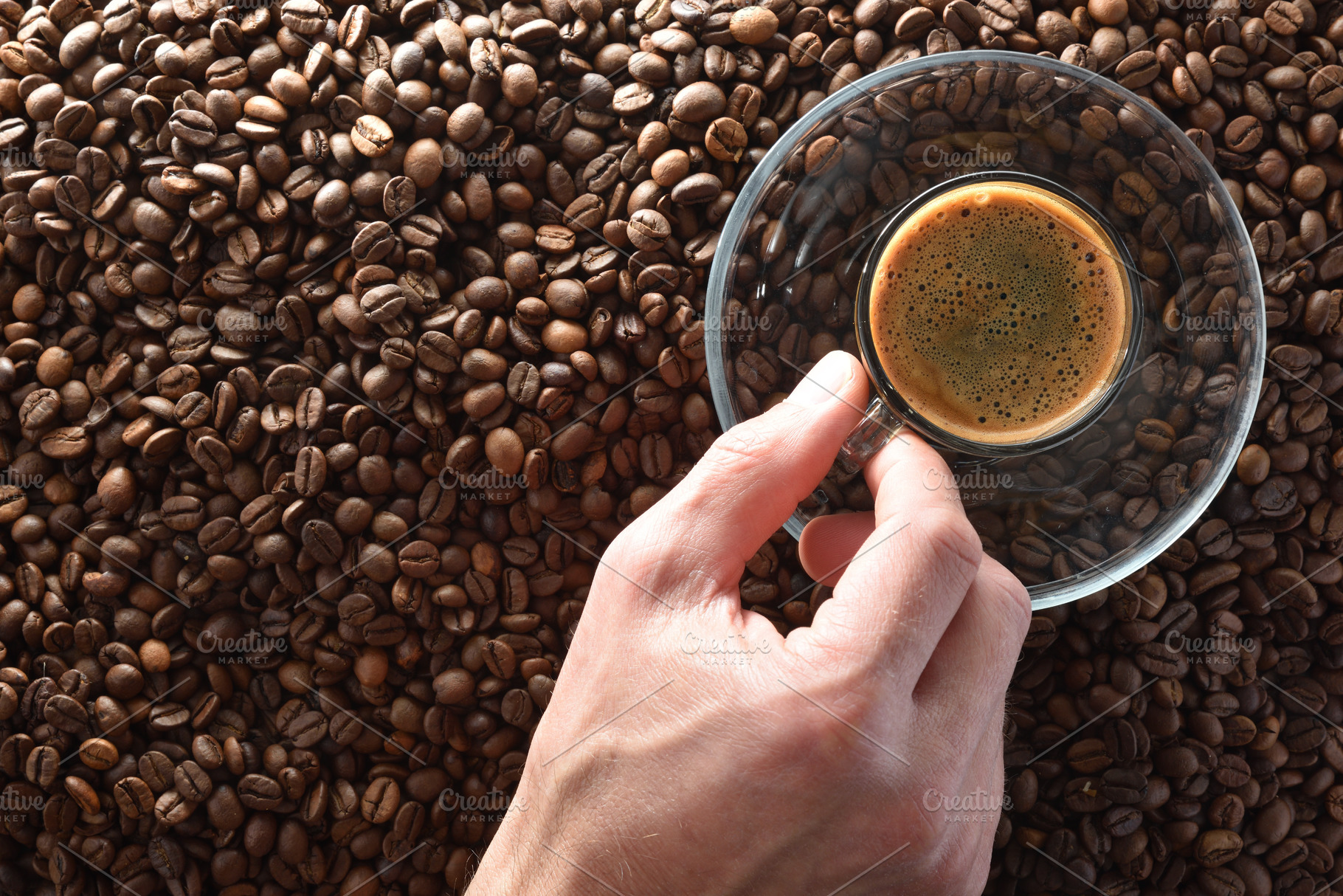 Hand taking cup of coffee to taste on coffee beans, a Food & Drink Photo by Davizro's Market