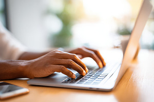 Hands typing on a laptop in a bright workspace, a Business Photo by AlyaAnd