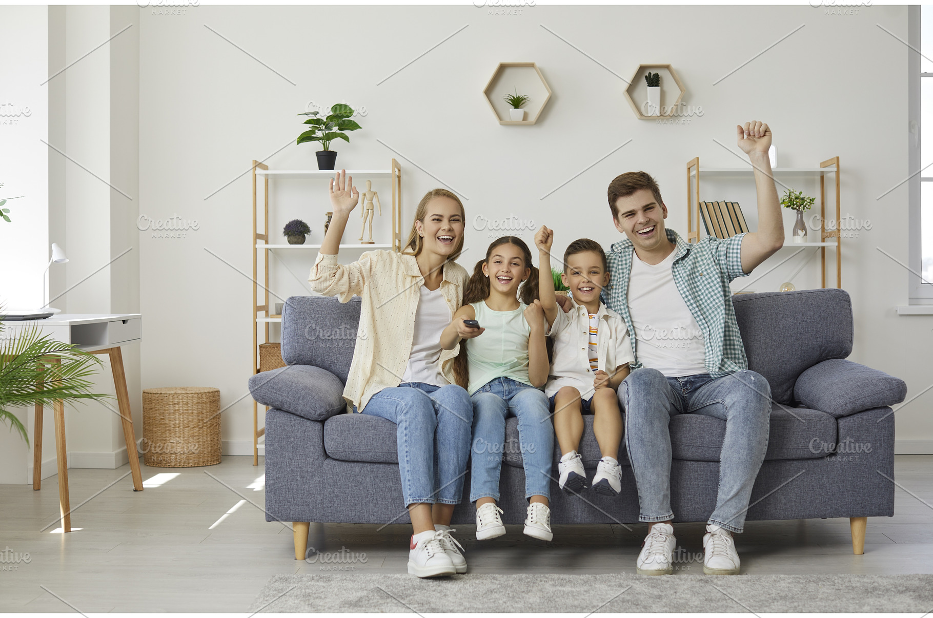 Happy family on couch is watching, a Person Photo by StudioRomantic