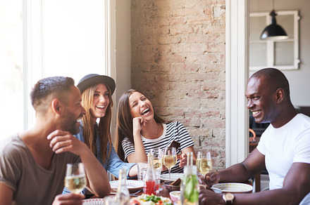 Four happy friends having wine and dinner together stock photo containing, a Person Photo by Stefan & Janni