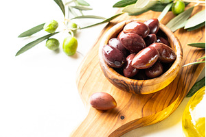 Olives in the bowl at white table., a Food & Drink Photo by Nadia-nb