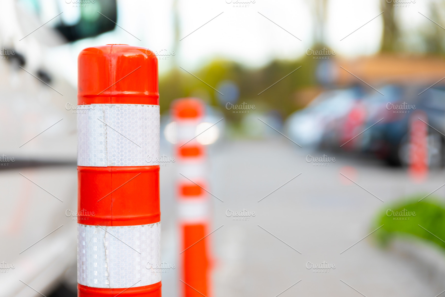 Close-up of an orange traffic bollard with reflective stripes on, a Transportation Photo by Ales Munt