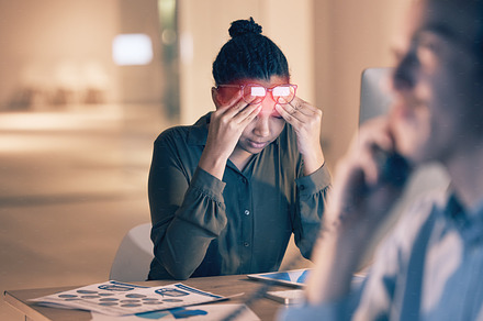 Business woman, headache and computer in stress, burnout or suffering pain at night by office desk. Female employee rubbing head or touching painful area by desktop PC feeling overworked at workplace, a Photo by Peopleimages.com