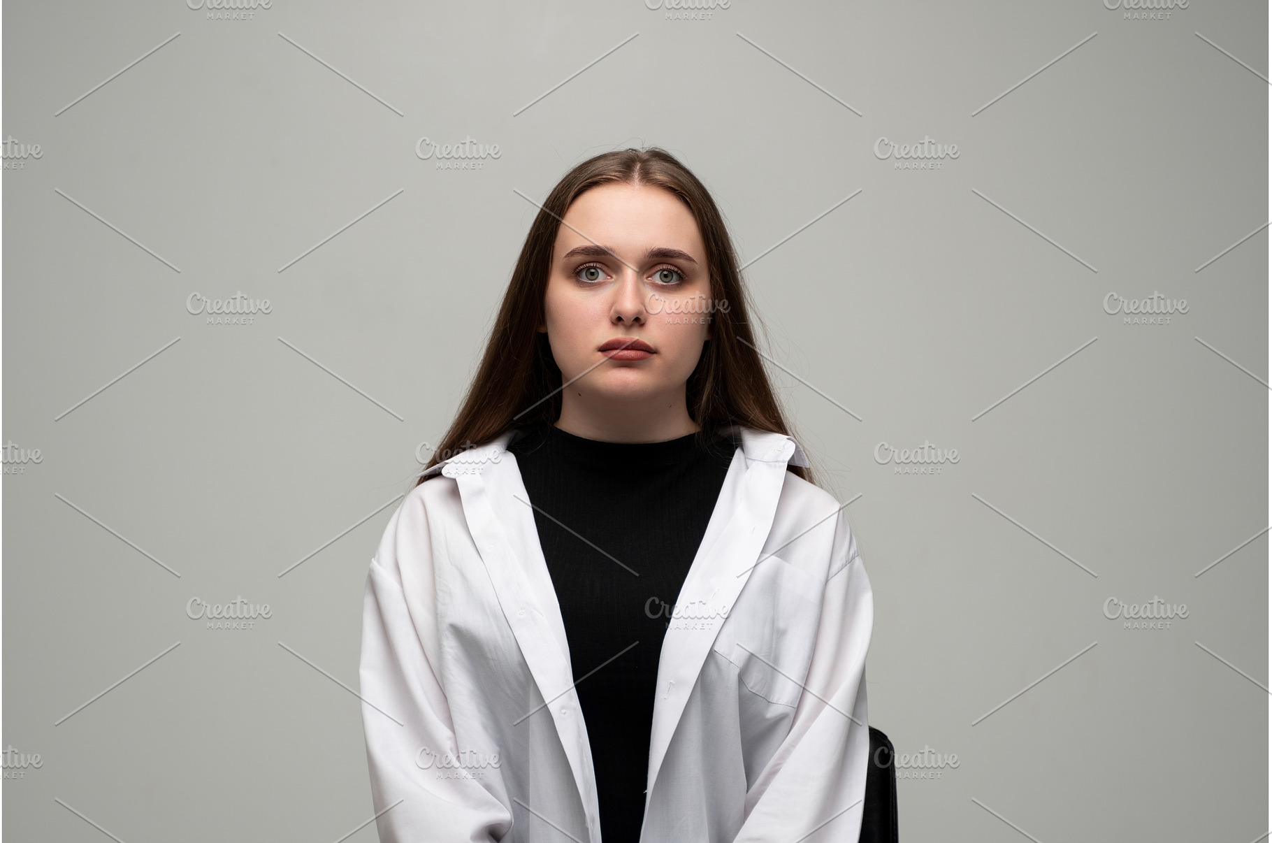 Young woman posing in a studio for a, a Person Photo by volodymyrshtun13795