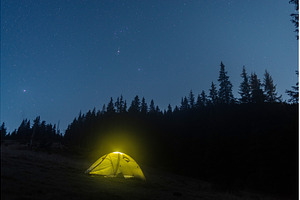 Illuminated camping tent under a, a Nature Photo by Stockphoto by vzwer
