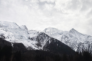 Charming alpine cabin nestled against snowy mountains in a serene Switzerland v, a Photo by AS photostudio
