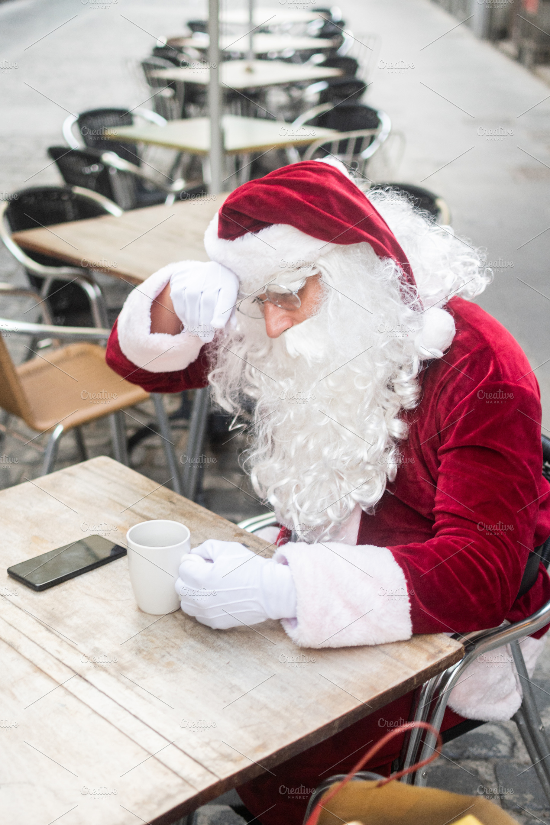 Tired Santa Claus resting at cafe with coffee, a Person Photo by etorres69
