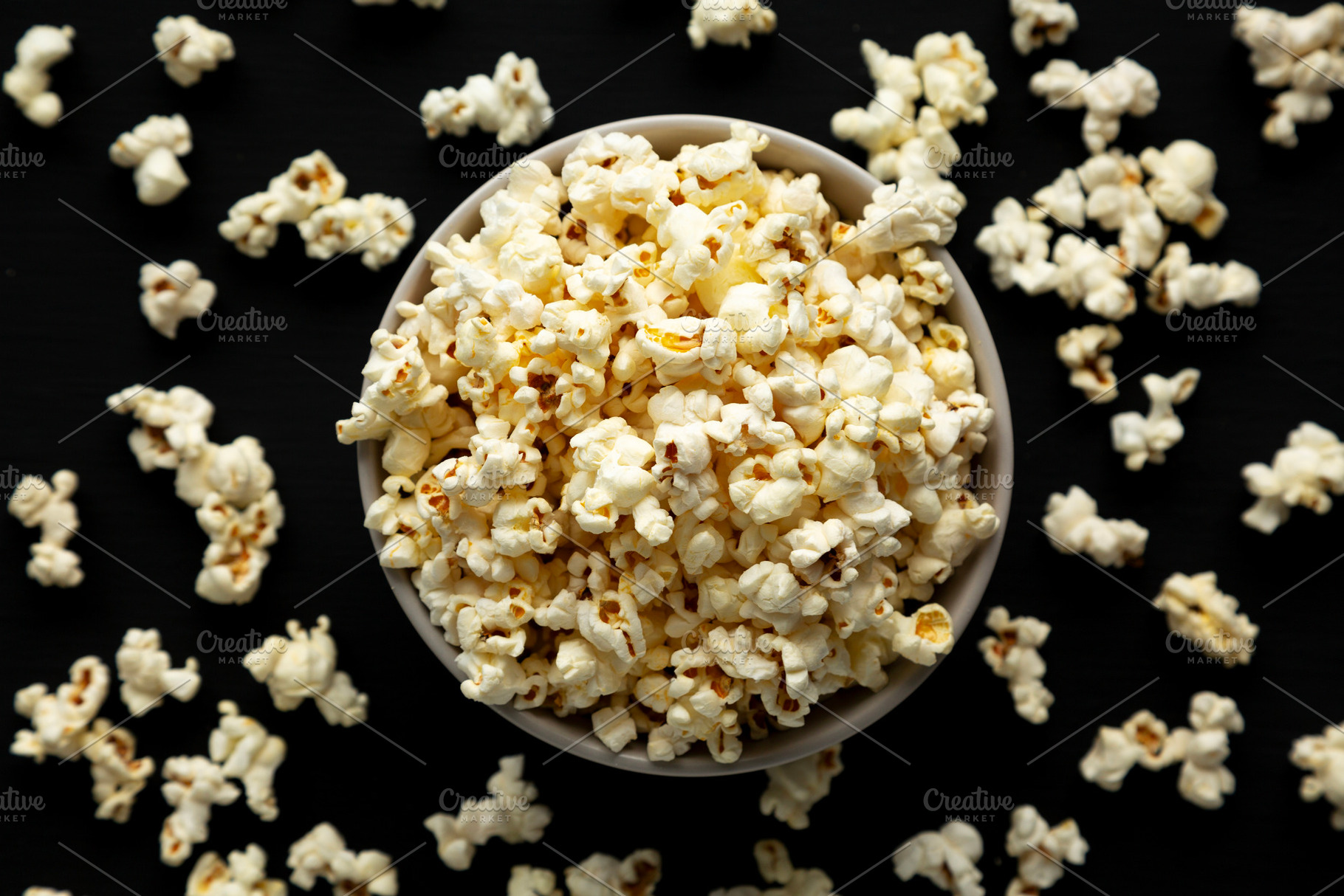 Homemade Butter Popcorn with Salt in a Bowl, top view., a Food & Drink Photo by LiudmylaChuhunova