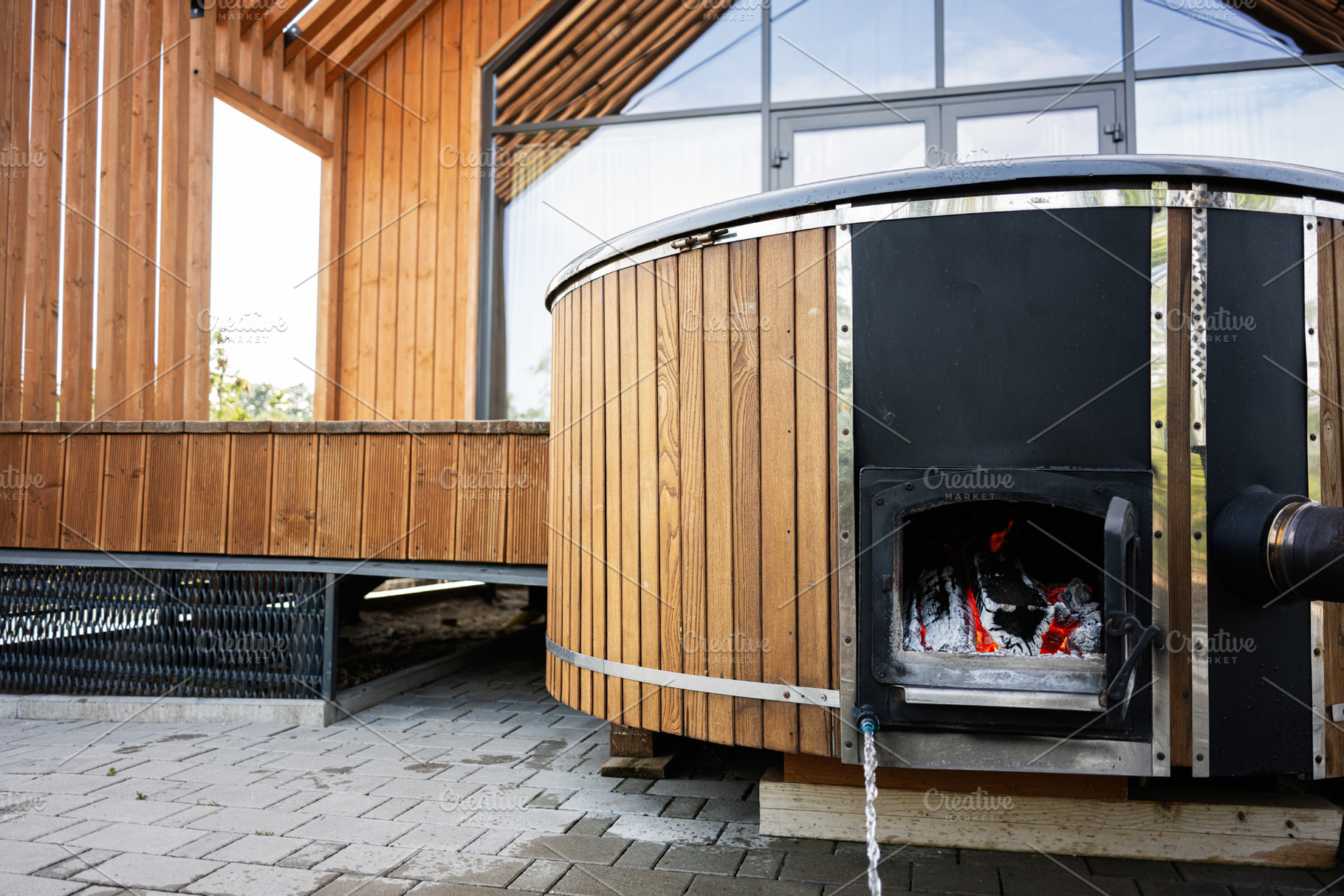 Wooden outdoor hot tub with stove in modern backyard setting, a Photo by AS photostudio