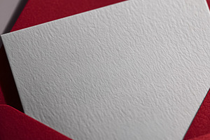 Red envelope with blank textured white card providing space for, a Photo by Studio ANNA
