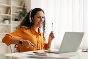 Middle Eastern Woman Listening Music Using Laptop Having Fun Indoors, a Photo by Prostock-Studio (Thumbnail 3 of 5)