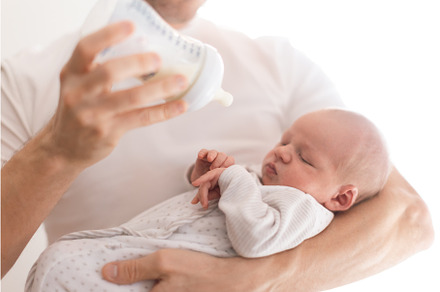 Father holding and feeding his, a Person Photo by HalfPoint