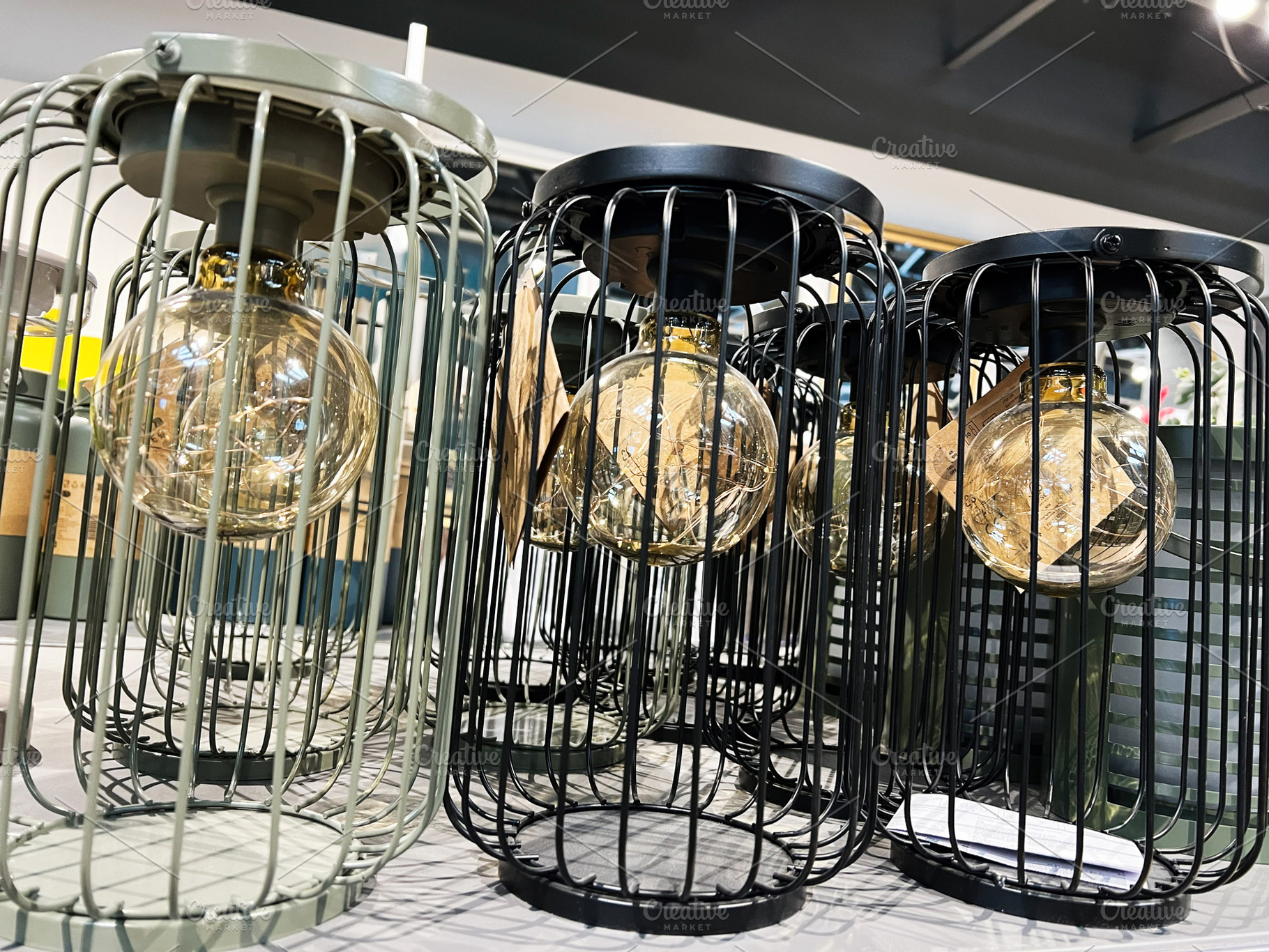 Modern industrial light fixtures with glass bulbs and wire designs, a Photo by AS photostudio