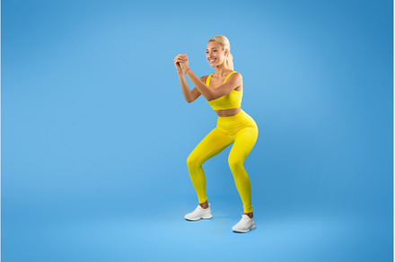 Smiling Young Woman Doing Deep Squat, a Person Photo by Prostock-Studio