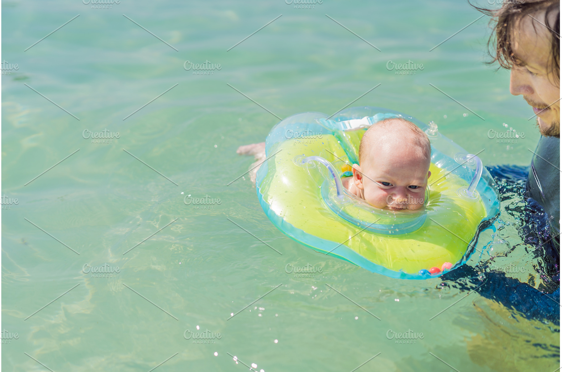 Father and newborn son swimming in, a Person Photo by Elizaveta Galitskaya