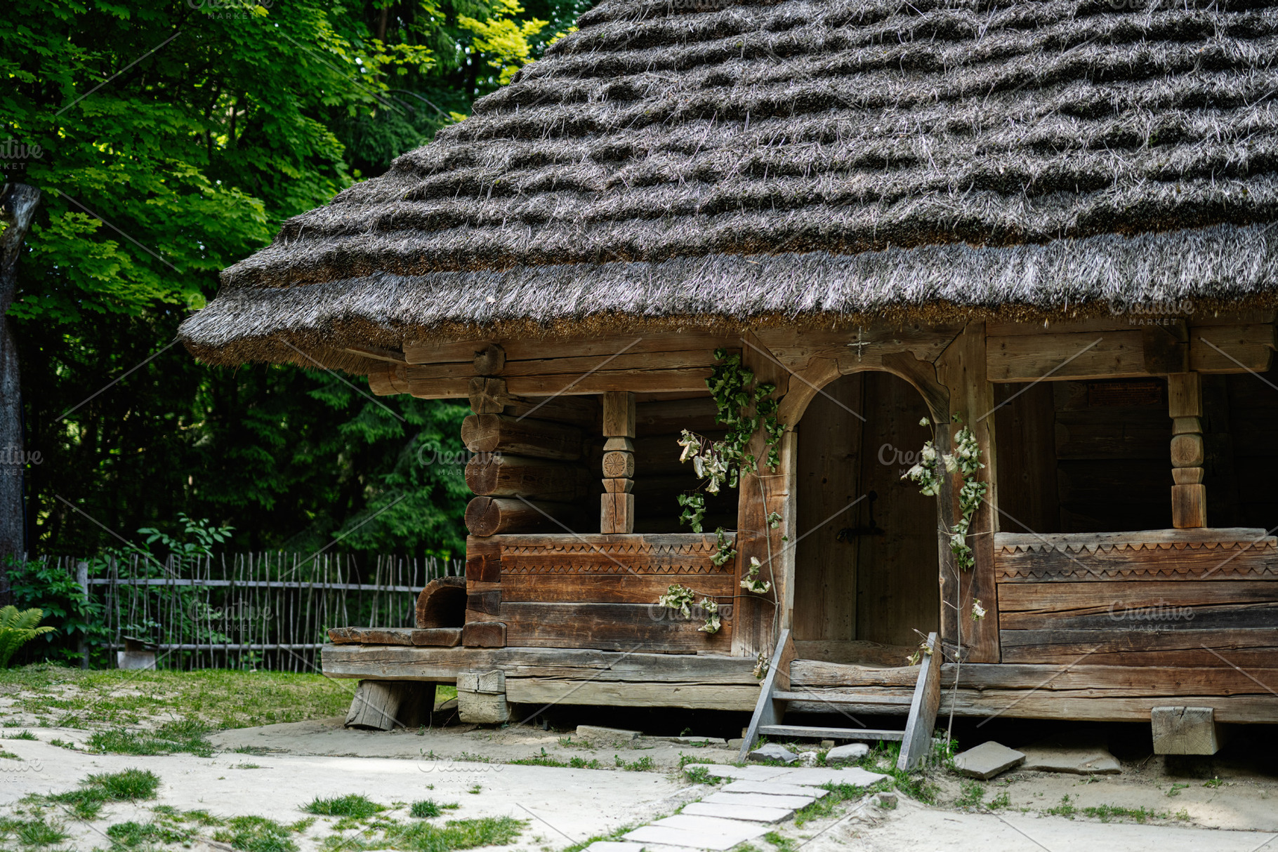 Rustic wooden hut with thatched roof surrounded by greenery, a Photo by ...