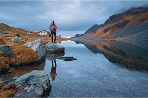 Young woman standing on a rock on, a Person Photo by den-belitsky