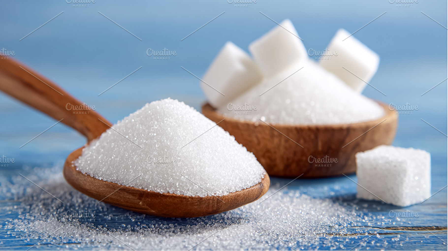 White granulated sugar and sugar cubes on a wooden spoon and in, a Photo by Studio ANNA