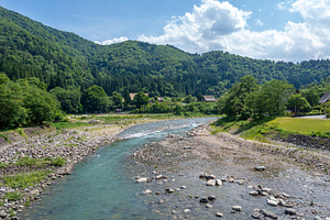 Sho River flowing through the village of Shirakawa-go, Japan, a Nature Photo by GoodGoods