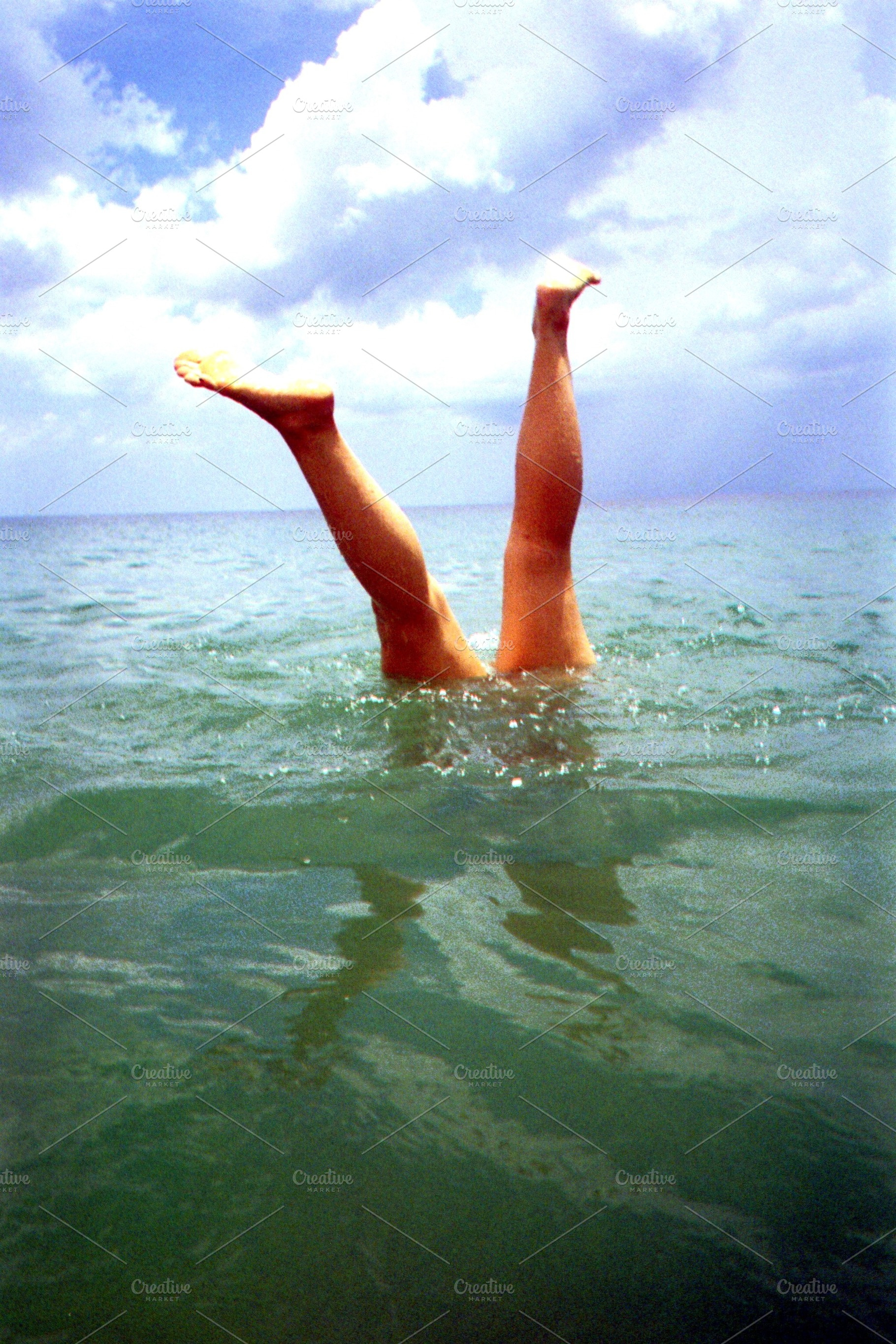 Feet Sticking Out of the Ocean Photo, a Person Photo by AmandaFagan