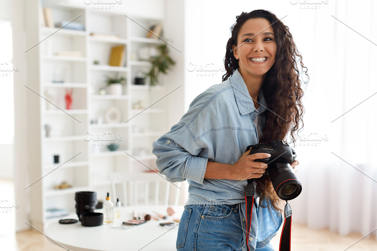 Cheerful Arabic Photographer Woman Holding Photo Camera Indoors, a Photo by Prostock-Studio (Photo 1 of 3)