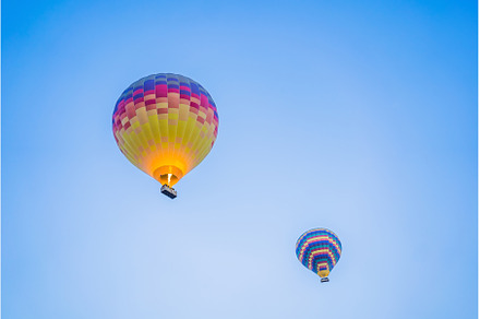 Beautiful hot air balloons over blue, a Transportation Photo by Elizaveta Galitskaya