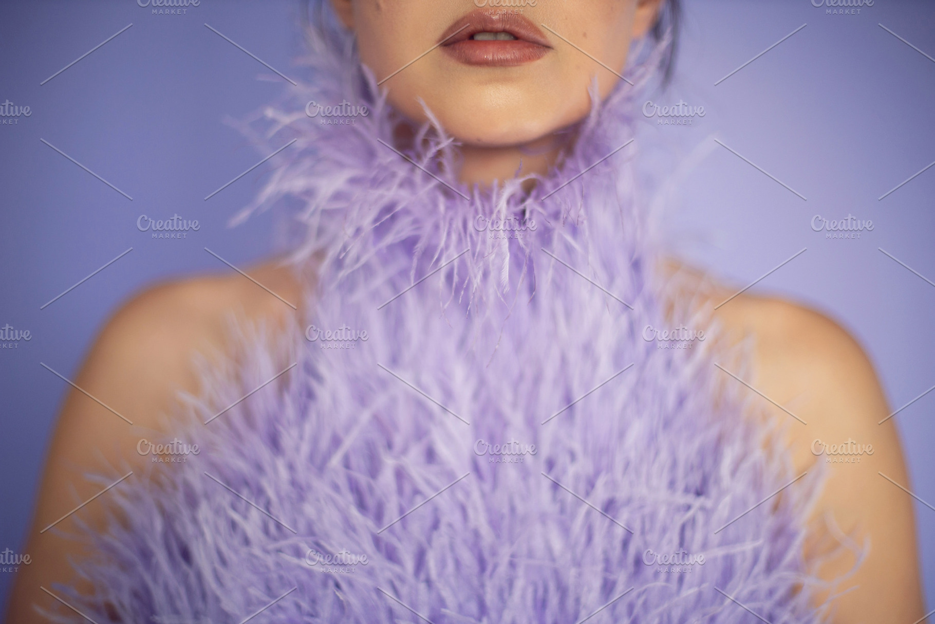 portrait woman in an evening purple dress with feathers stands in the backgroun, a Person Photo by SaulichPhoto
