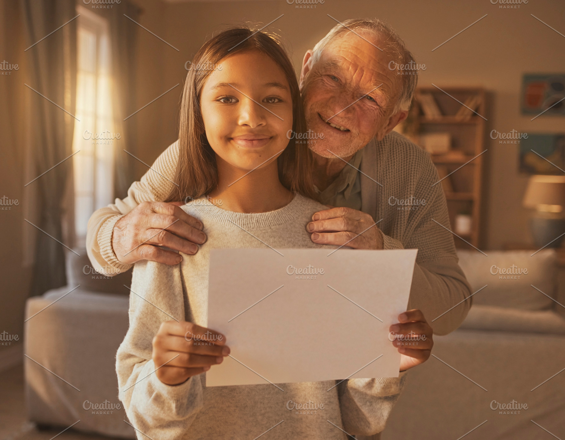 Older person with younger person holding blank paper, a Photo by DanFLCreativo
