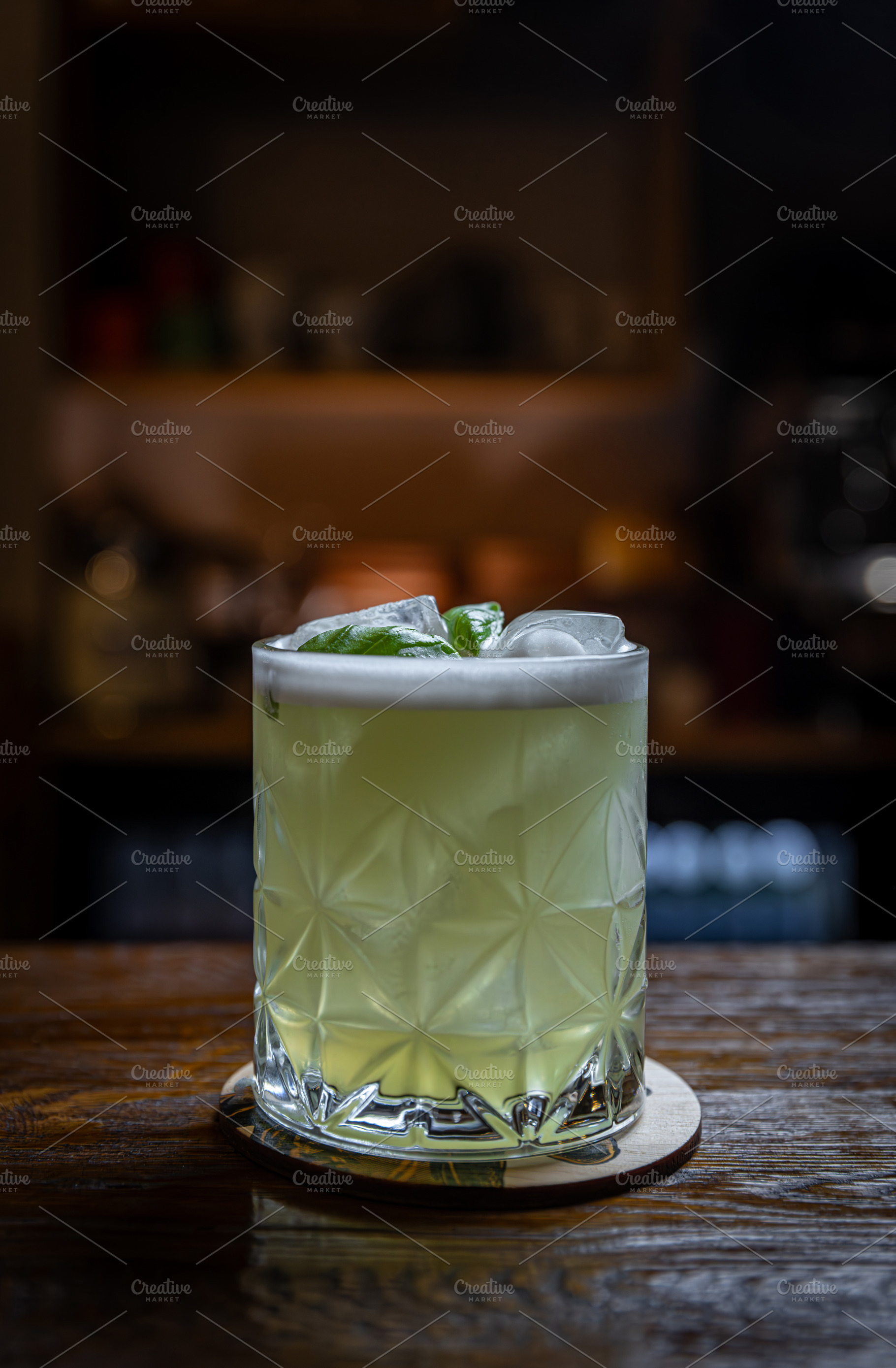 Basil cocktail on wooden bar, a Photo by Grafvision photography