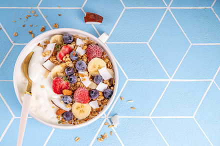 Breakfast yogurt granola bowl with fruit and berry, a Food & Drink Photo by Rimma