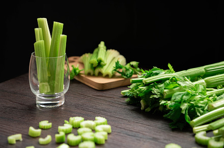 Bunch of fresh celery stalk on wooden table with leaves prepared, a Food & Drink Photo by Ministocker