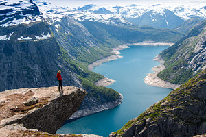 Traveler woman standing on a cliff stock photo containing hill and outdoor