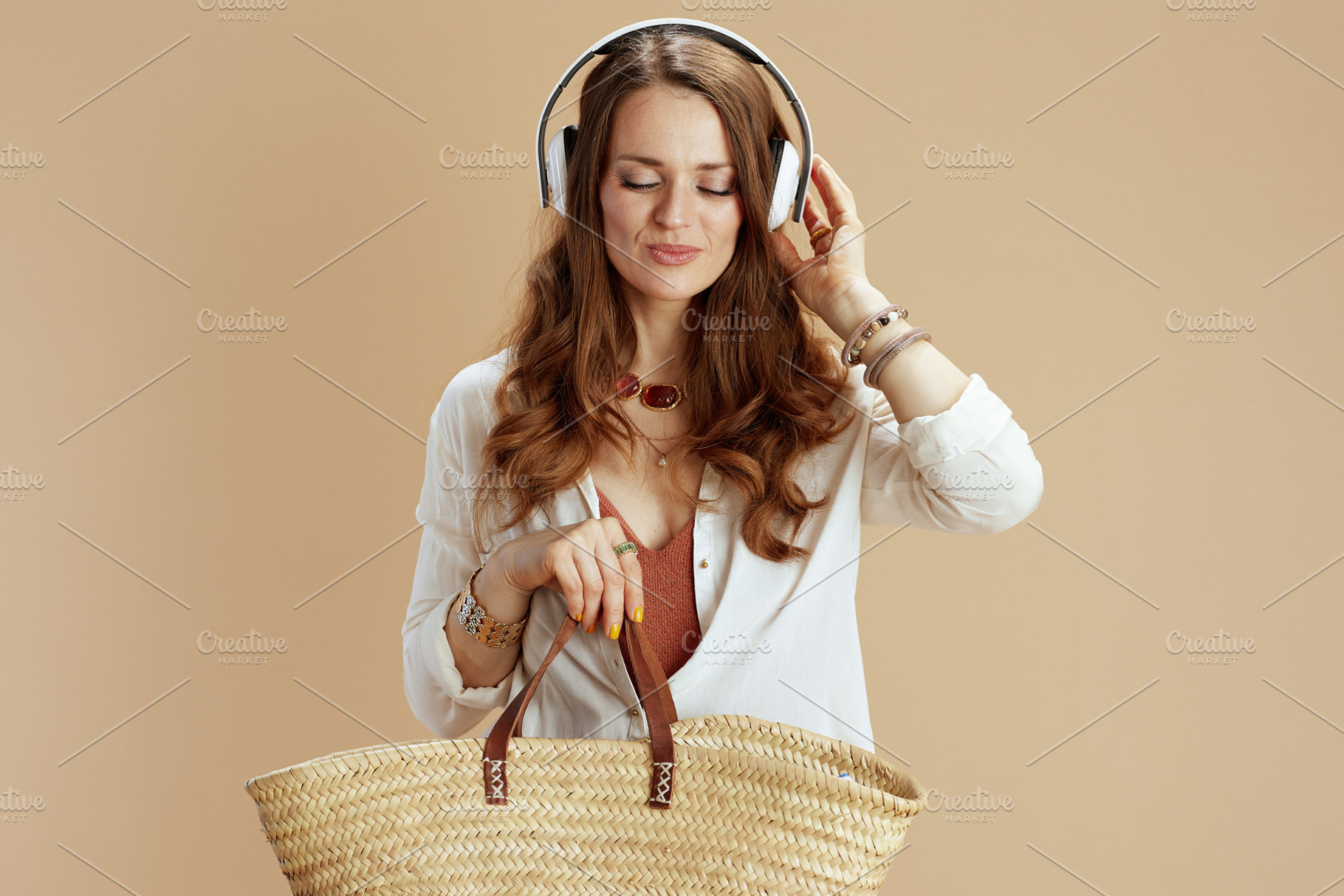 relaxed elegant woman in blouse and shorts on beige, a Person Photo by Alliance Images